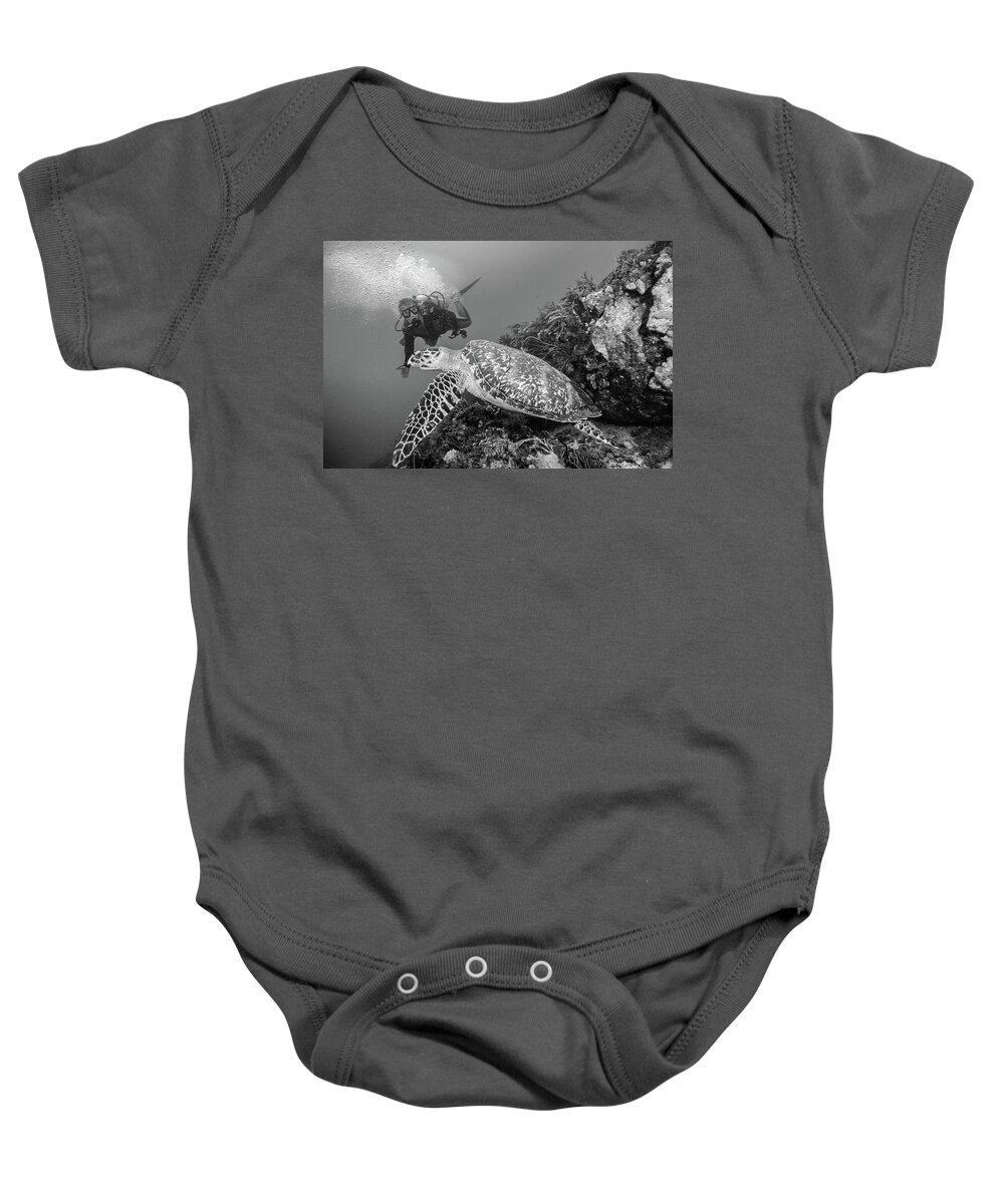 Black Baby Onesie featuring the photograph Loggerhead Turtle and Diver Black and White by Debra and Dave Vanderlaan