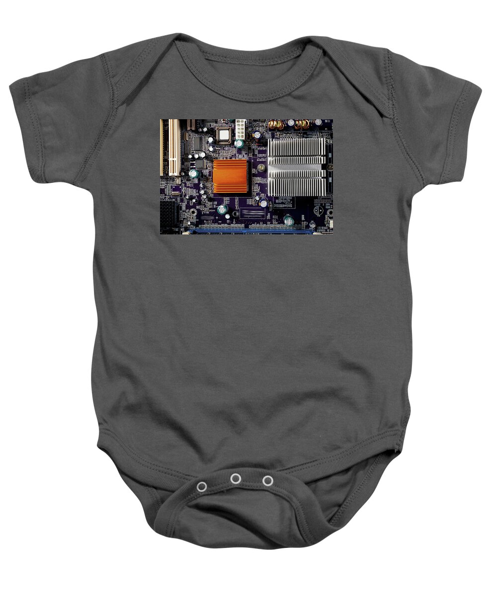 Computer Baby Onesie featuring the photograph Mainboard of a pc with electronic components. by Bernhard Schaffer