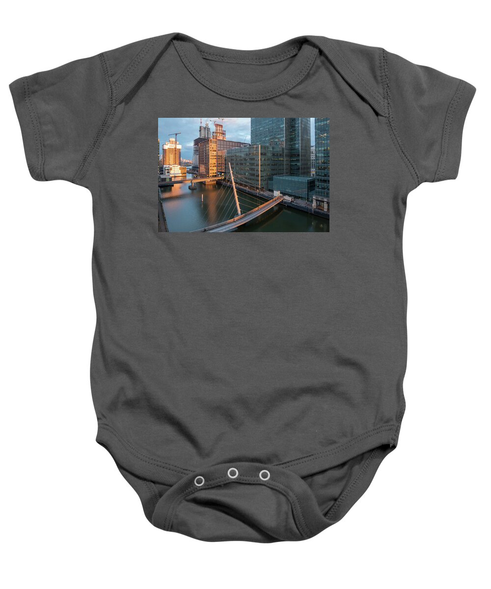 Canary Wharf Baby Onesie featuring the photograph Modern office building in the Canary Wharf financial centre in the evening. London united kingdom by Michalakis Ppalis