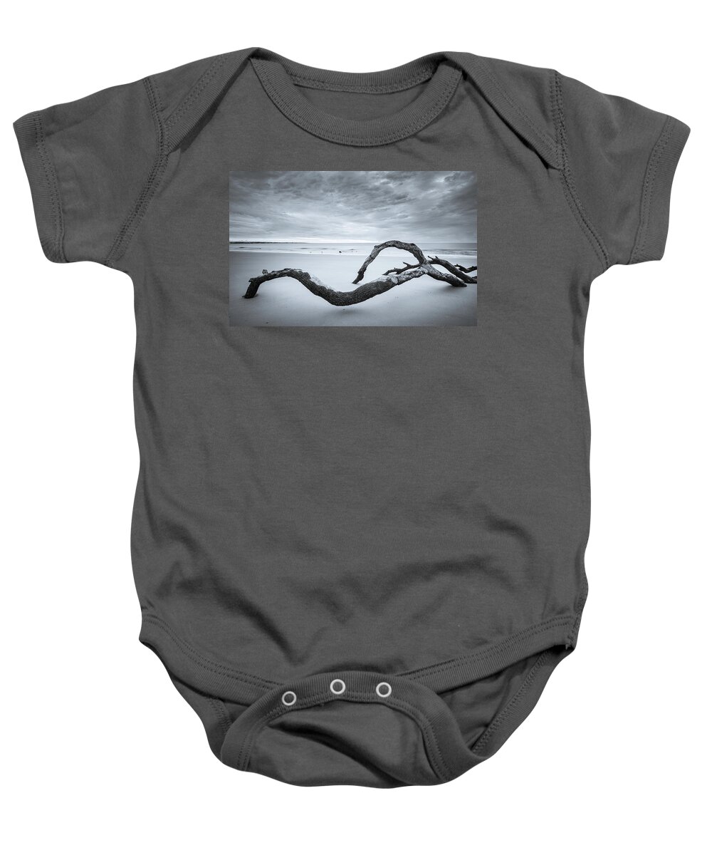 Driftwood Beach Baby Onesie featuring the photograph Serene Driftwood Beach In Black And White by Jordan Hill