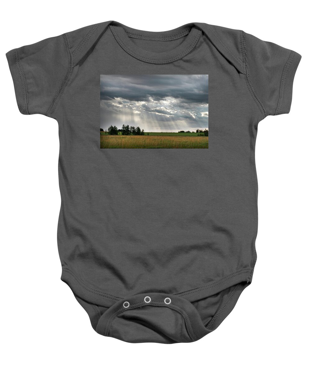 Sun Baby Onesie featuring the photograph Sun rays over a field by Karen Rispin