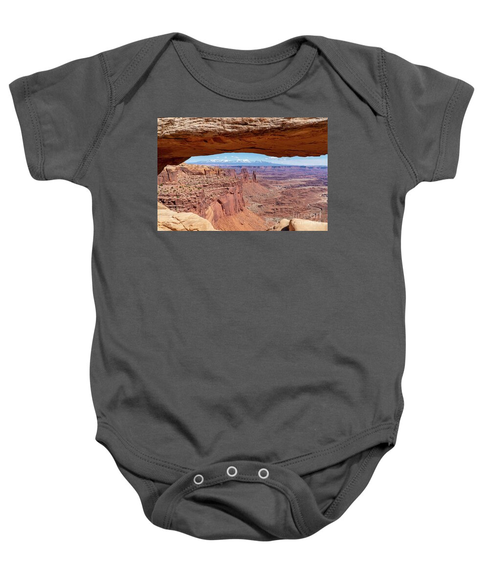 Canyonlands National Park Baby Onesie featuring the photograph The Washerwoman Arch is framed by the Mesa Arch at Canyonlands N by William Kuta