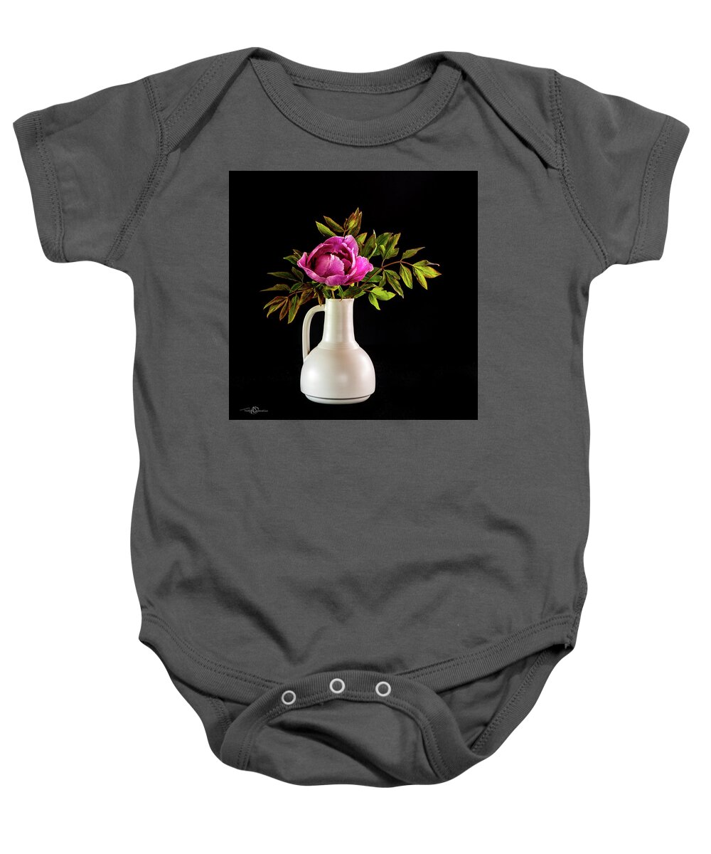 Tree Peony Baby Onesie featuring the photograph Tree peony Lan He Paeonia suffruticosa rockii in a white vase on a black background by Torbjorn Swenelius