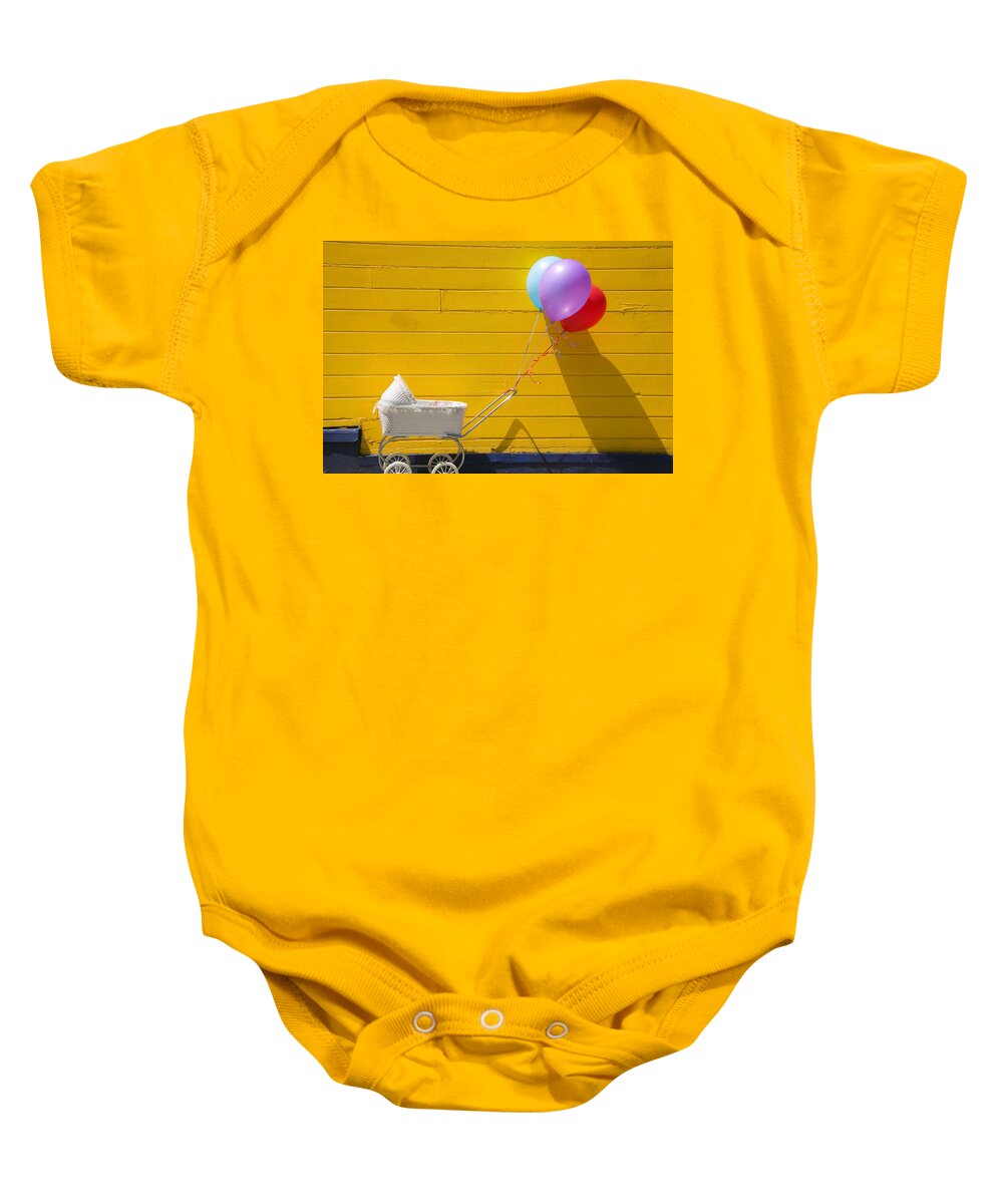 Wheel Baby Onesie featuring the photograph Buggy and yellow wall by Garry Gay