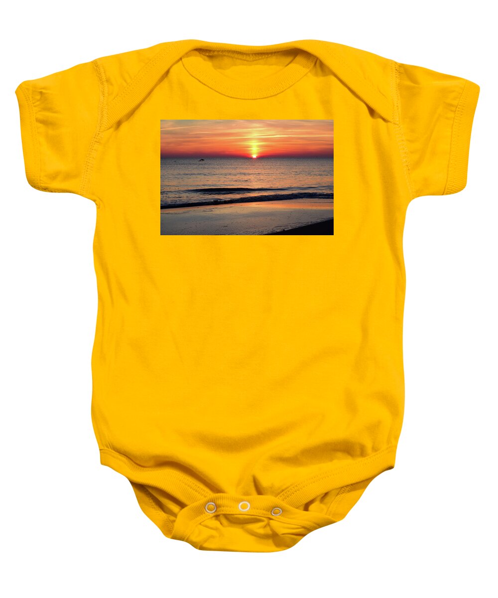 Dolphin Baby Onesie featuring the photograph Dolphin Jumping in the Sunrise by Nicole Lloyd