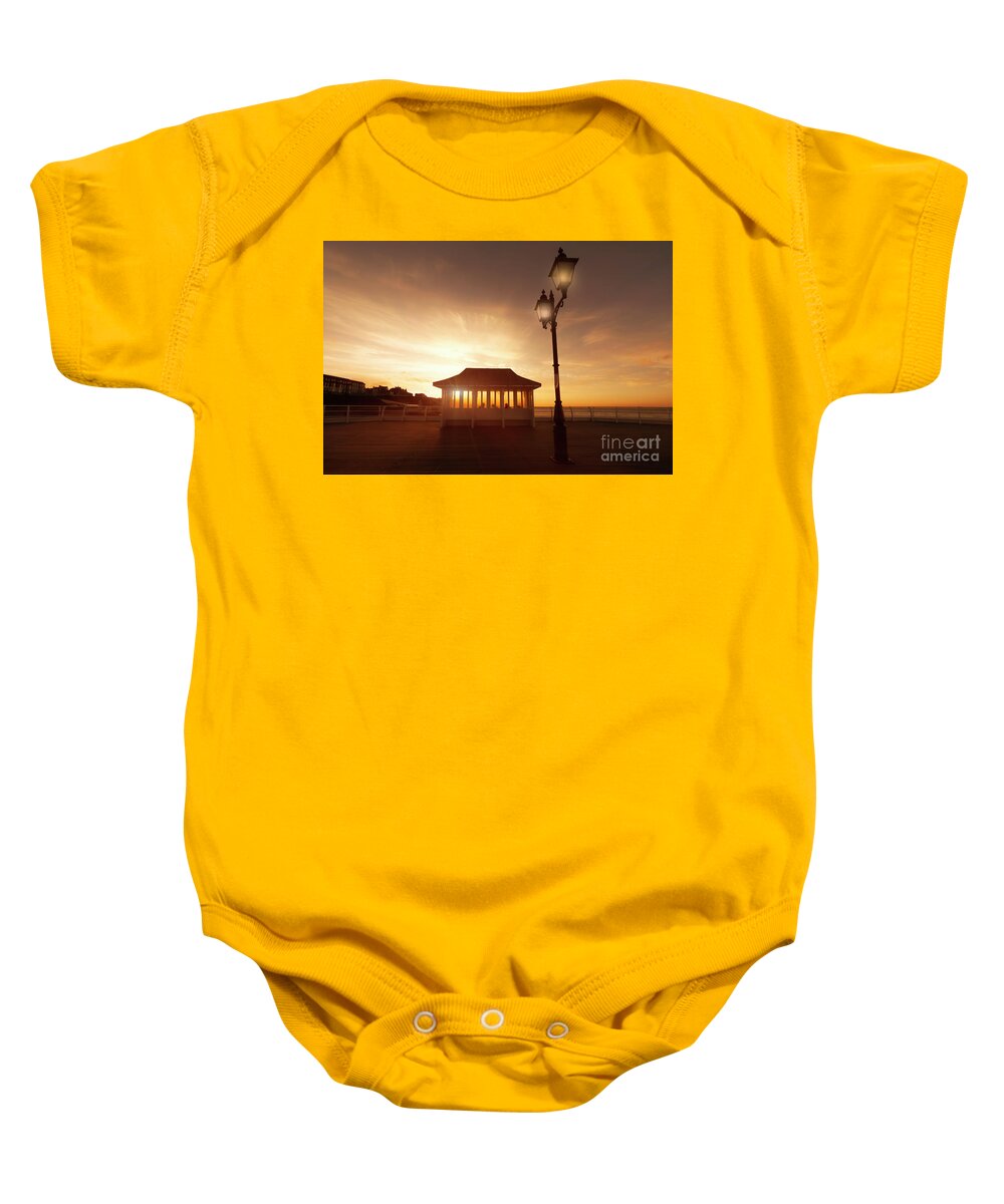 Norfolk Baby Onesie featuring the photograph Cromer pier in Norfolk England shelter at sunset by Simon Bratt