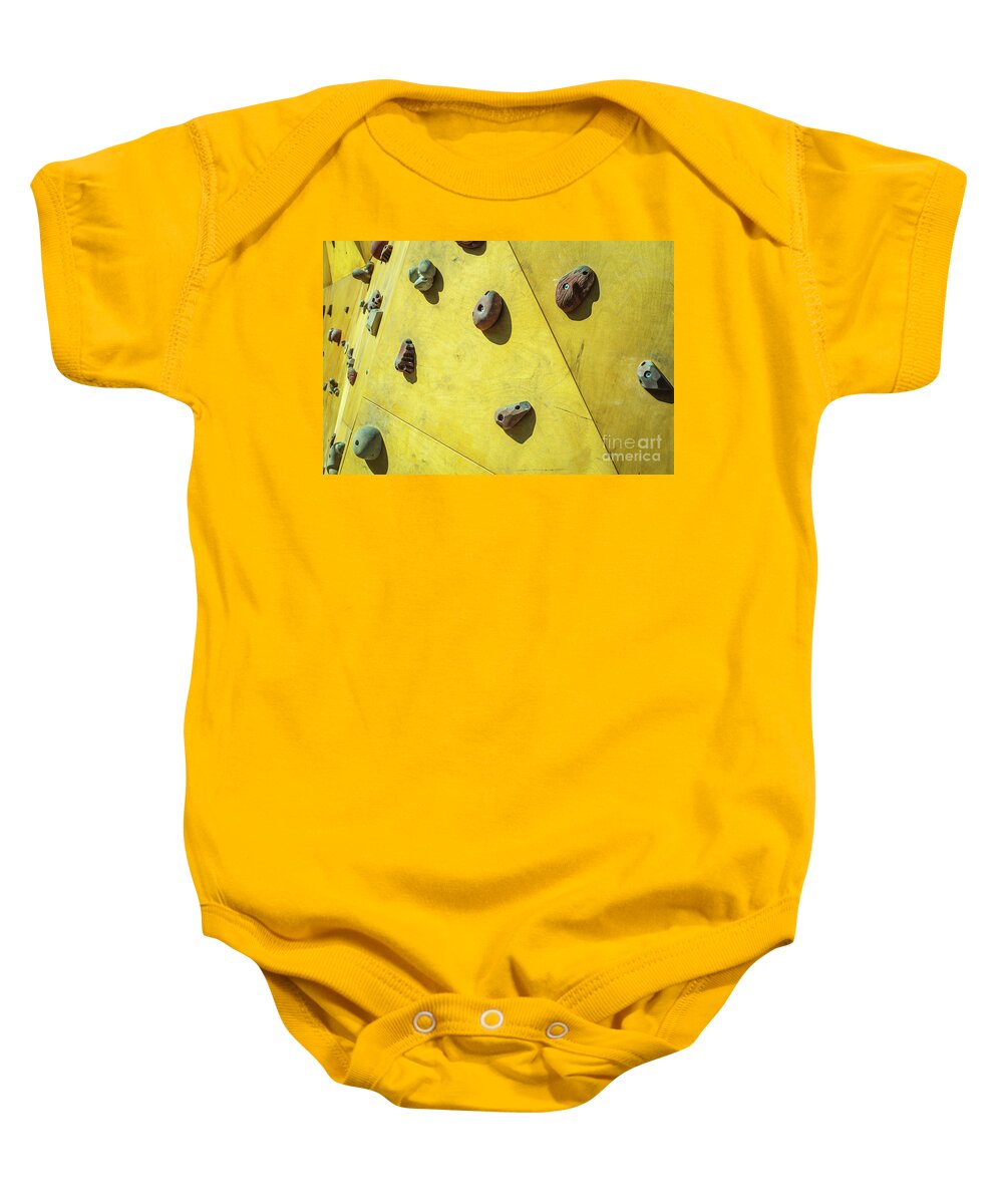 Architecture Baby Onesie featuring the photograph Detail of the wall of an outdoor climbing wall to practice climbing by Joaquin Corbalan