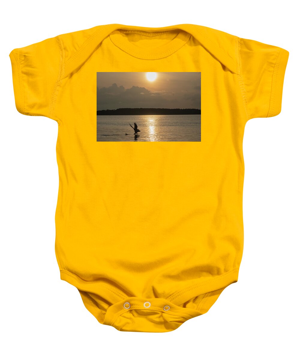 Pelican Baby Onesie featuring the photograph A Pelican Going Fishing at Sunset by Dennis Schmidt