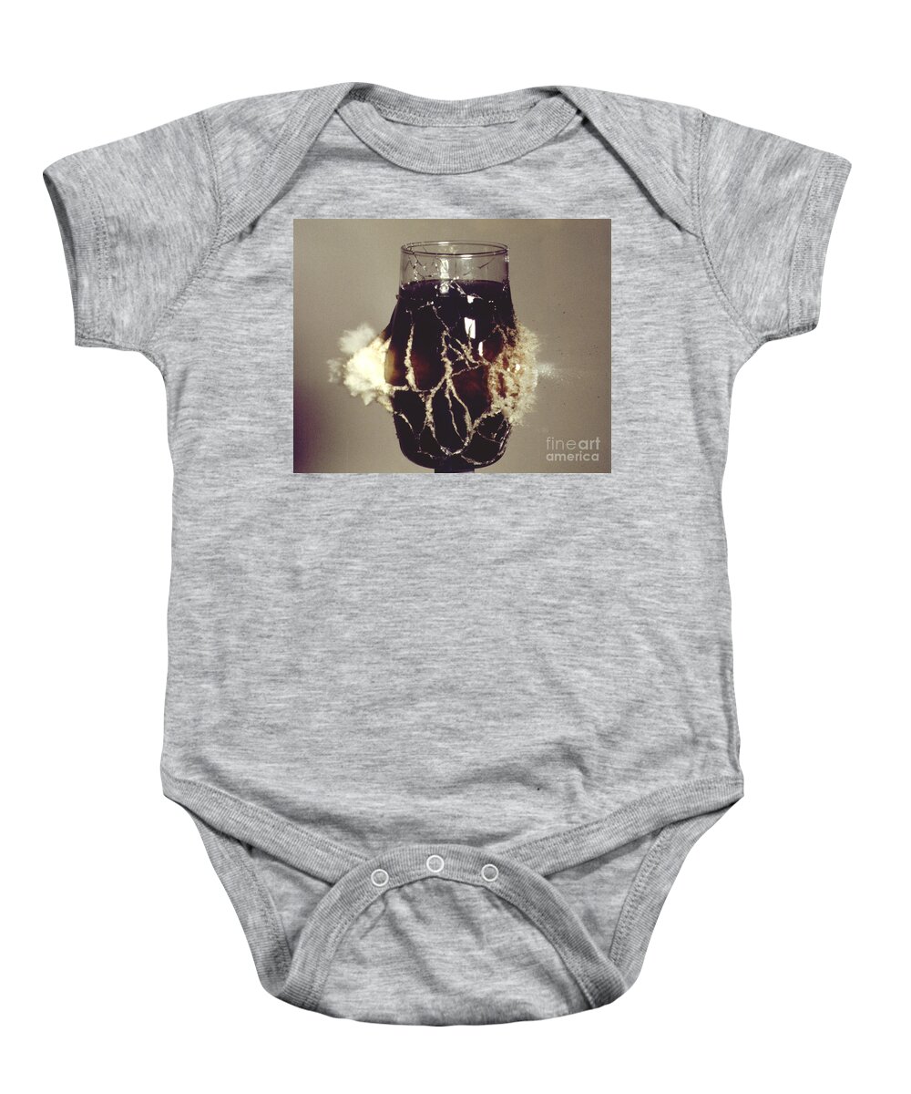 High Speed Photography Baby Onesie featuring the photograph Bullet Piercing Glass Of Soda by Gary S. Settles