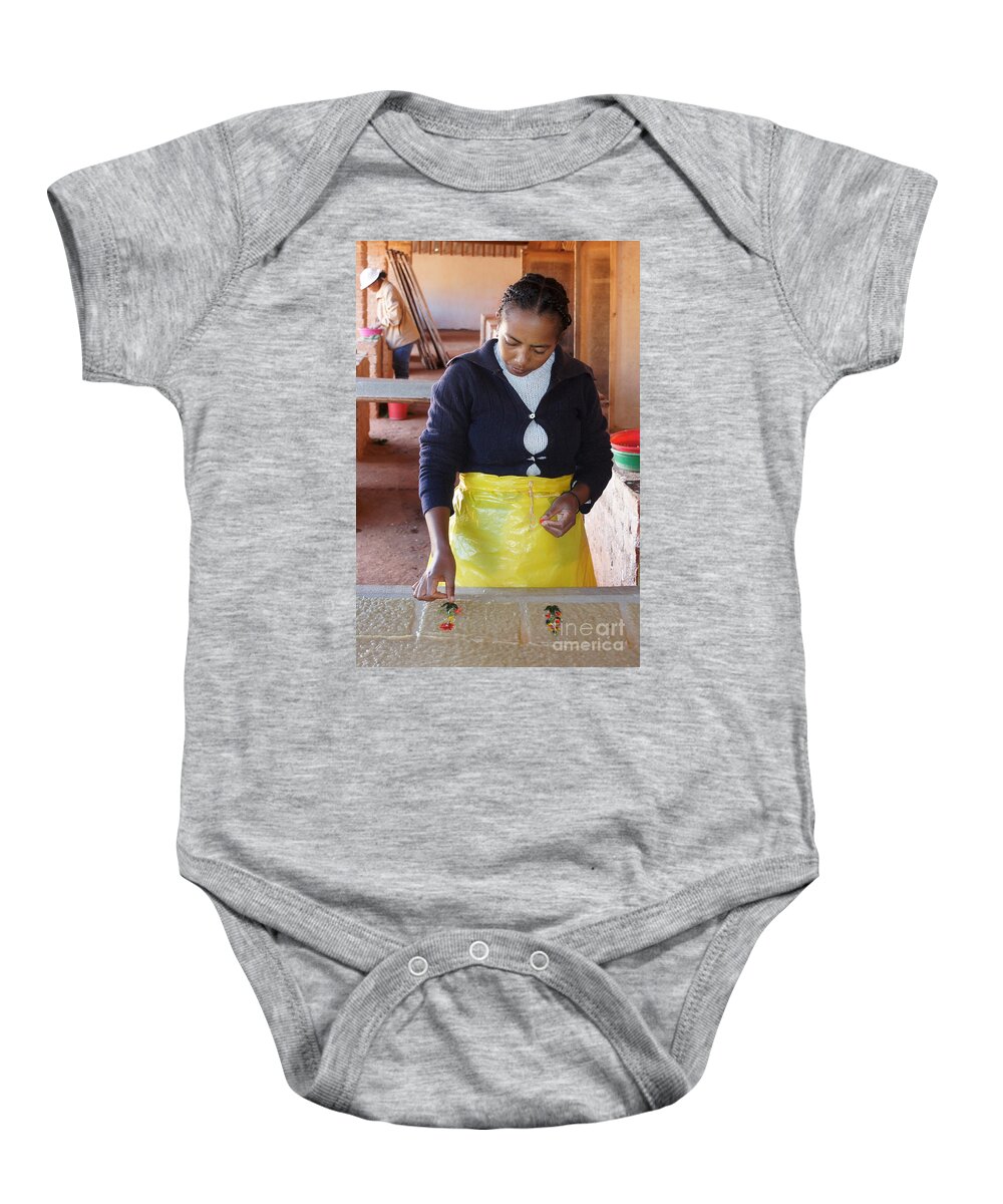 Madagascar Baby Onesie featuring the photograph hand papermaking in Madagascar 2 by Rudi Prott