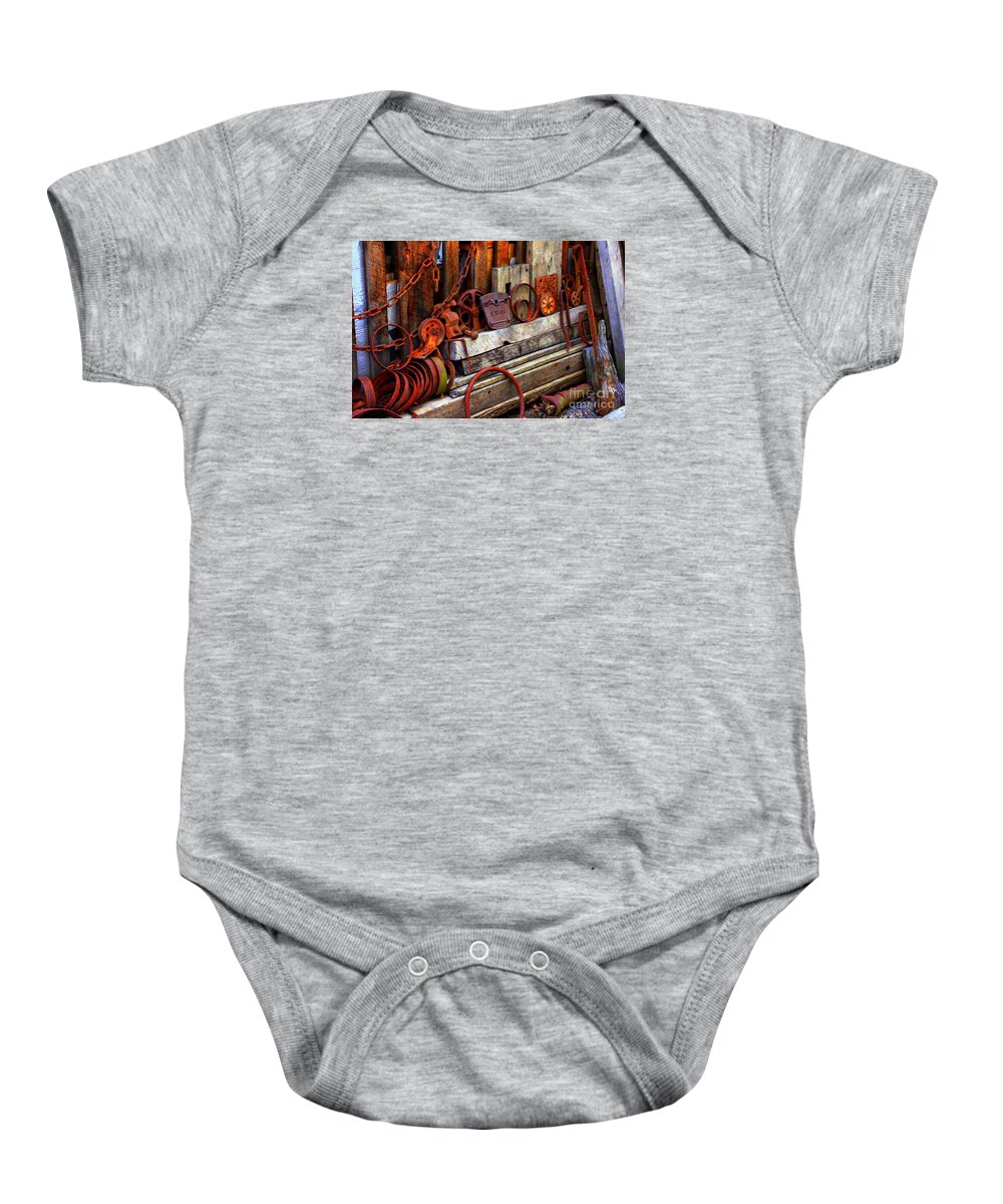 Marcia Lee Jones Baby Onesie featuring the photograph Weathered Rims And Chainss by Marcia Lee Jones