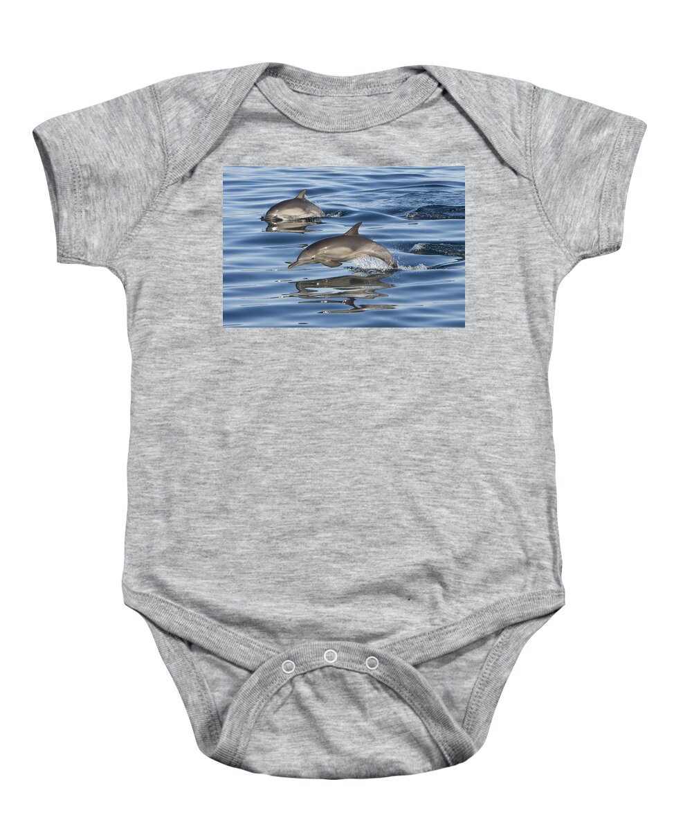 00447973 Baby Onesie featuring the photograph Longbeaked Common Dolphins Porpoising #1 by Suzi Eszterhas