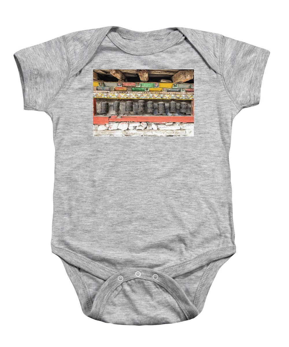 Ancient Baby Onesie featuring the photograph Tibetan Buddhism prayer wheels in Manang #1 by Didier Marti
