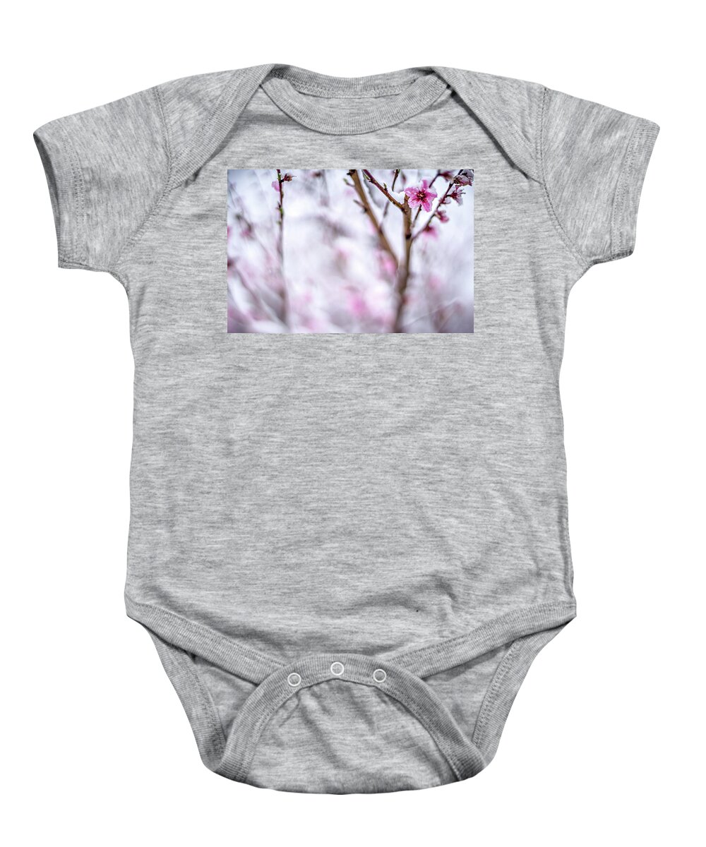 Winter Baby Onesie featuring the photograph Peach Tree Farm During Spring Snow With Blossoms #4 by Alex Grichenko