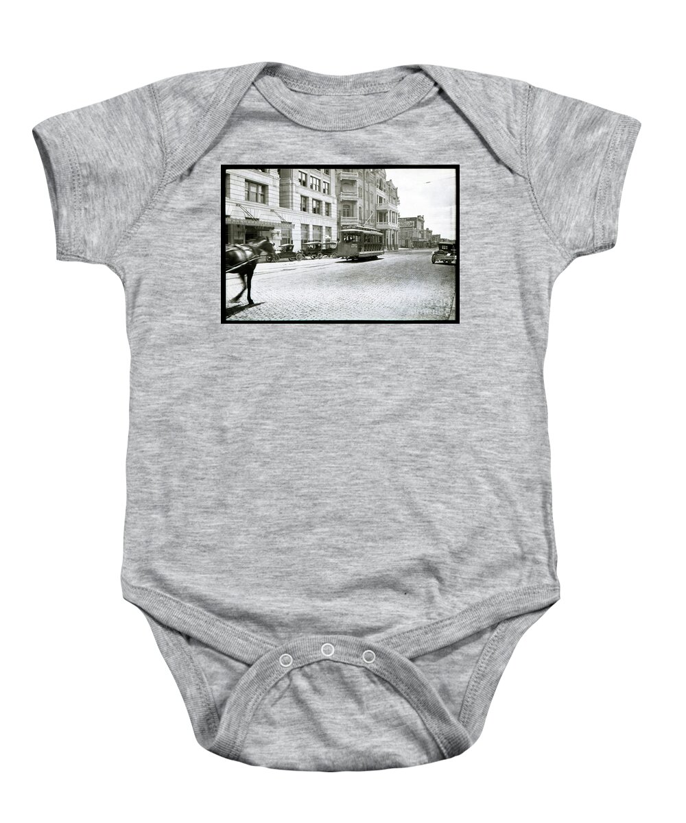 Cable Car Baby Onesie featuring the photograph A cable car drives past the Littlefield Building and Driskill Hotel on 6th in downtown Austin, Texas by Dan Herron