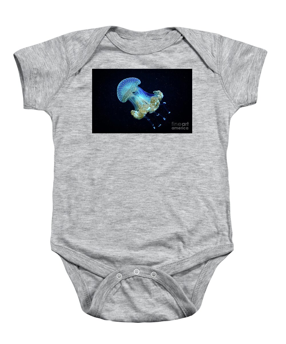 Protection Baby Onesie featuring the photograph Blue transparent jellyfish floats through water by Andreas Berthold