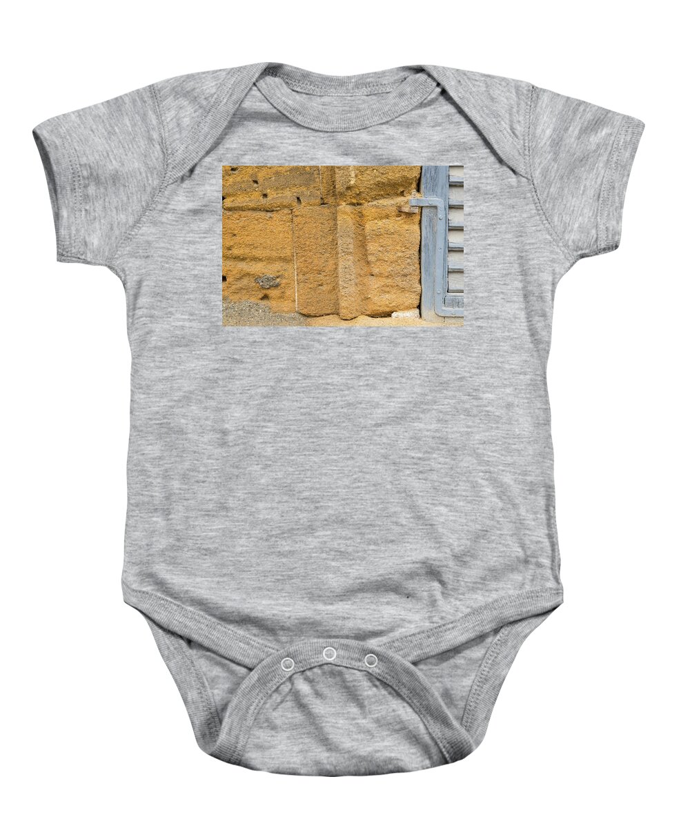 Window Baby Onesie featuring the photograph Blue window on a grungy yellow wall by Michalakis Ppalis