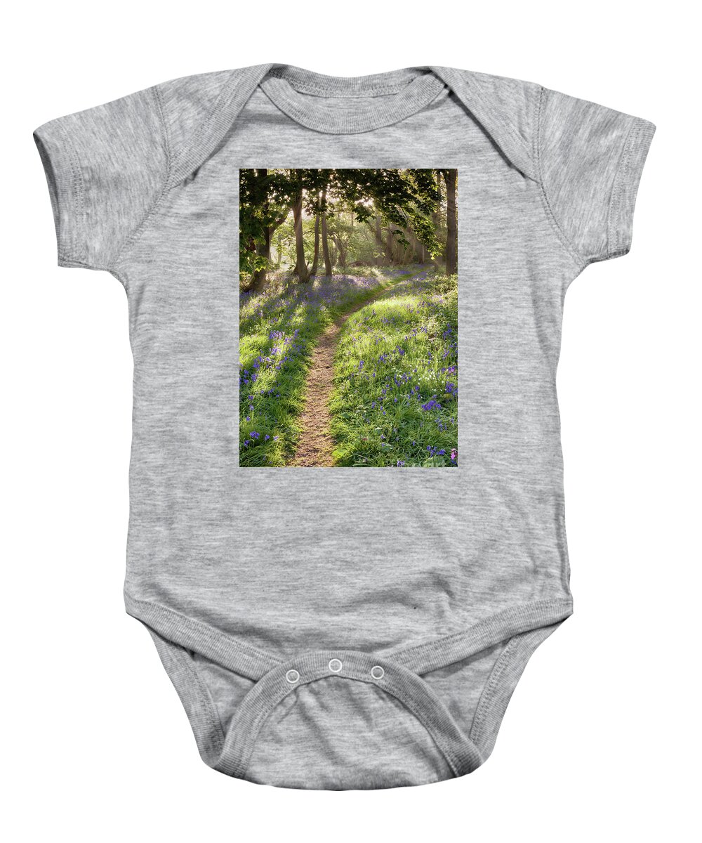 Bluebell Forest Baby Onesie featuring the photograph Bluebell woodland path with dreamy sunrise by Simon Bratt