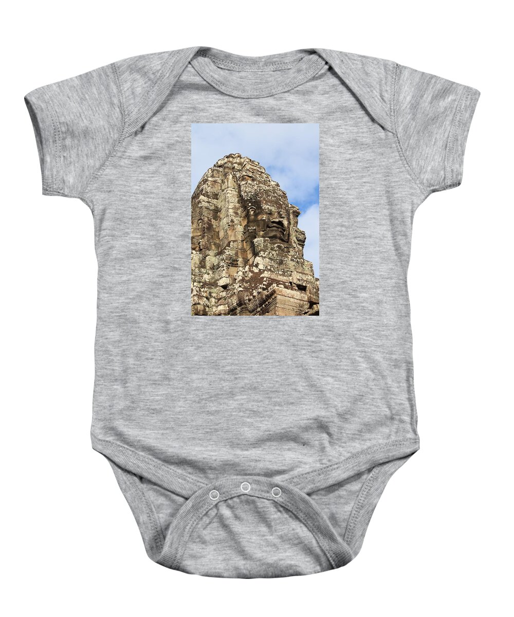Ancient Baby Onesie featuring the photograph Carved stone face at Bayon Temple, Angkor Wat, Cambodia by John Cumbow