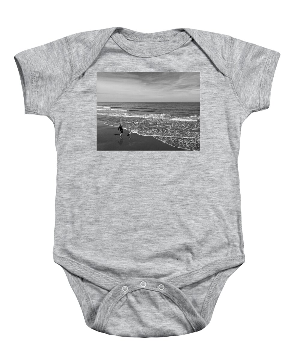 The North Sea Baby Onesie featuring the photograph Chasing The Tide in Black and White by Joan-Violet Stretch