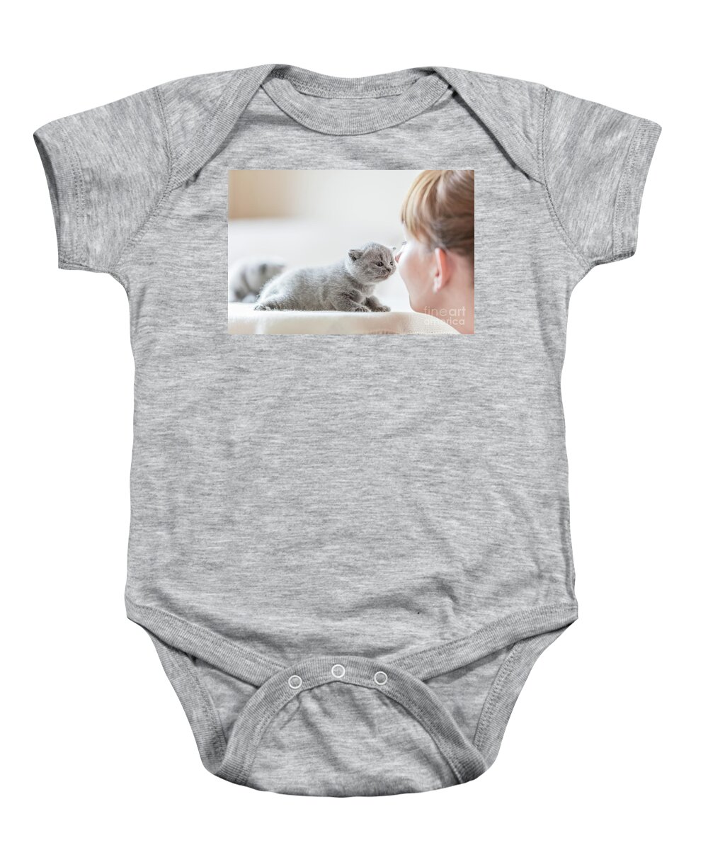 Cat Baby Onesie featuring the photograph Cute little cat and woman rubbing noses. by Michal Bednarek