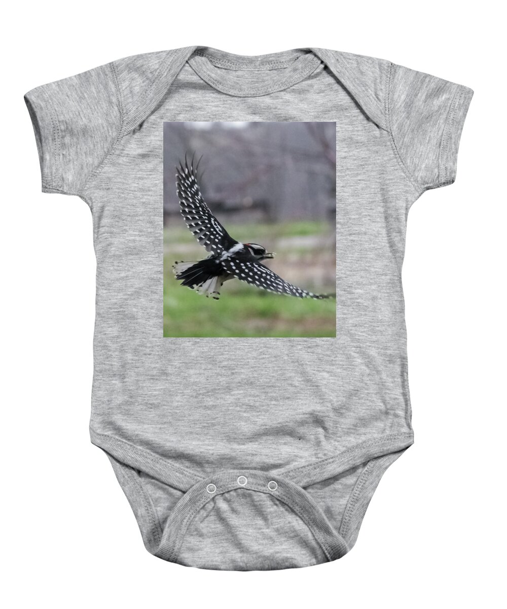 Jan Baby Onesie featuring the photograph Downy Woodpecker in Flight by Holden The Moment