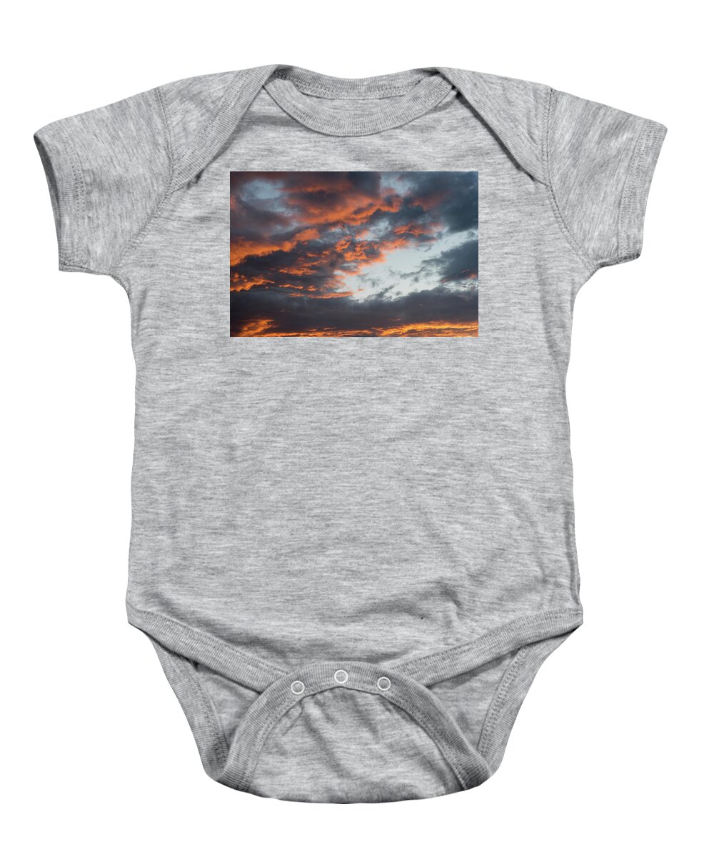 Stormy Clouds Baby Onesie featuring the photograph Dramatic sunset sky with orange cloud colors by Michalakis Ppalis