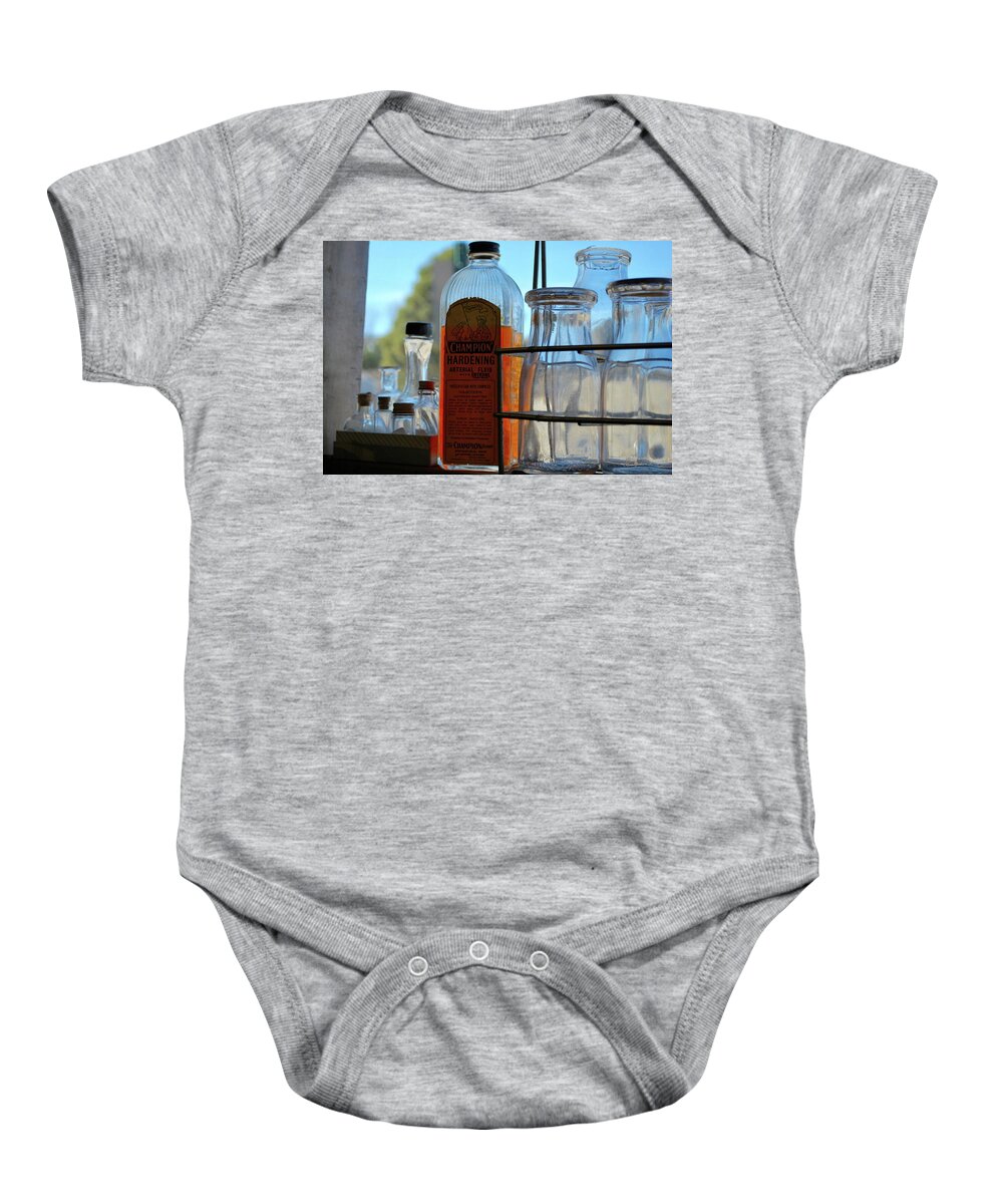 Embalming Fluid Baby Onesie featuring the photograph Expired on the shelf by Amee Cave