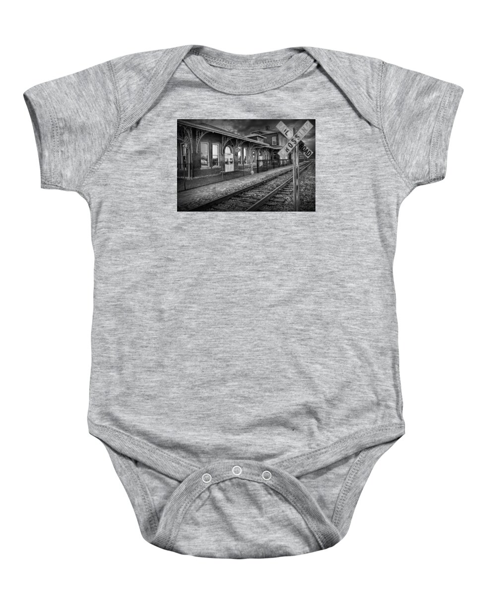 Station Baby Onesie featuring the photograph Old Train Station with Crossing Sign in Black and White by Randall Nyhof