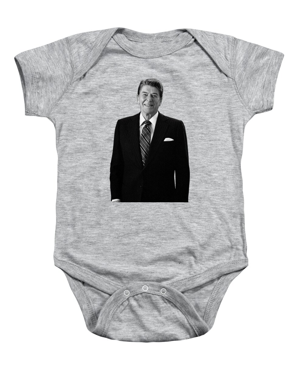 Ronald Reagan Baby Onesie featuring the photograph President Ronald Reagan In The Oval Office by War Is Hell Store