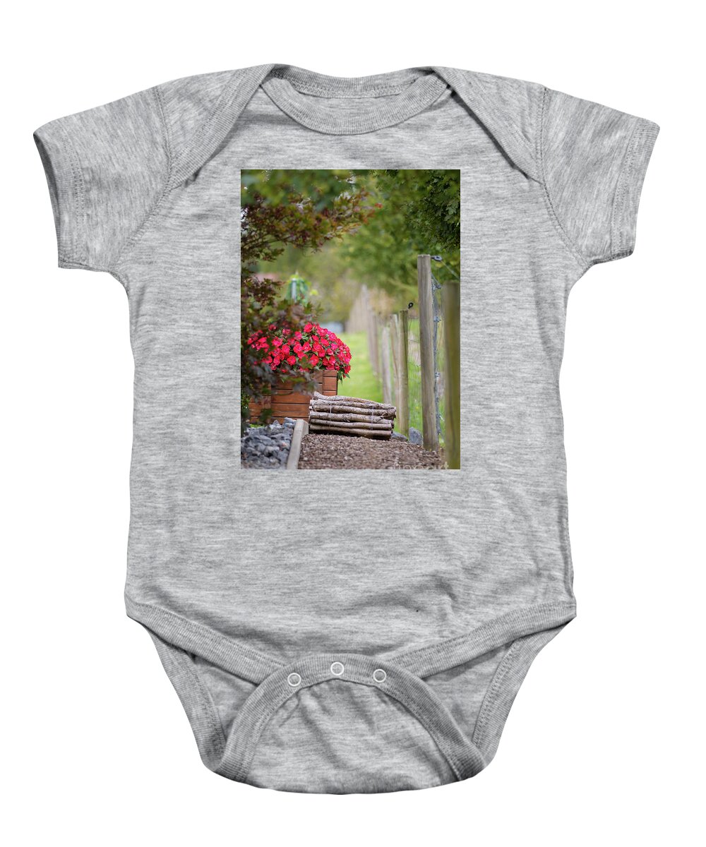 Country Baby Onesie featuring the photograph Red flowerd with Fende and wood billet bundle by Amanda Mohler