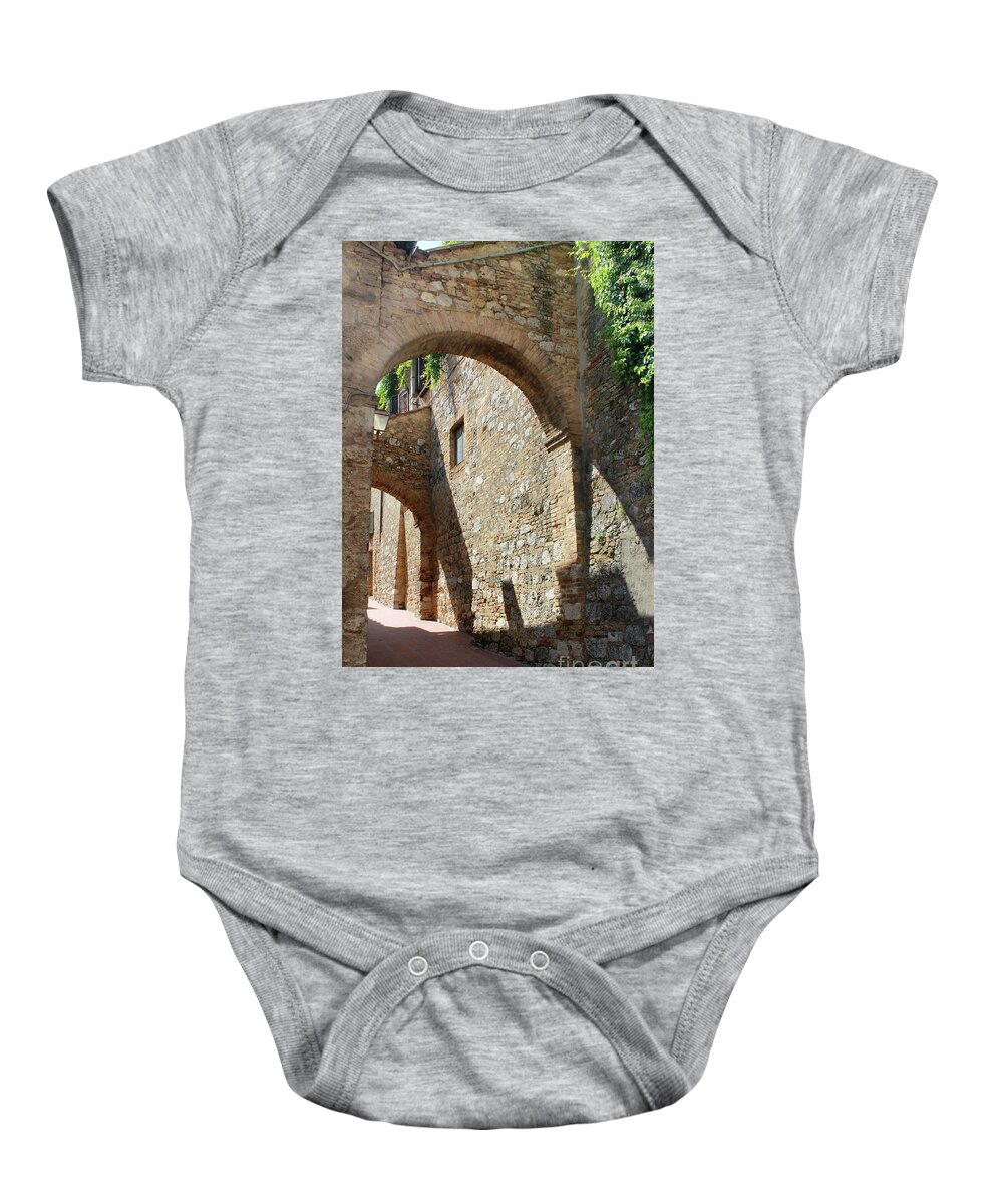 Italy Baby Onesie featuring the photograph San Gimignano Arched street in Italy by Adam Long