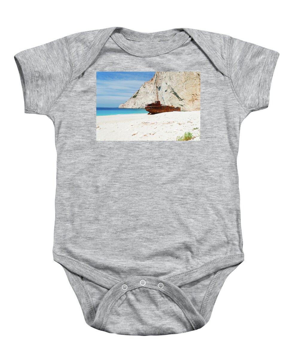 Navagio Baby Onesie featuring the photograph Shipwreak Beach II by Anastasy Yarmolovich