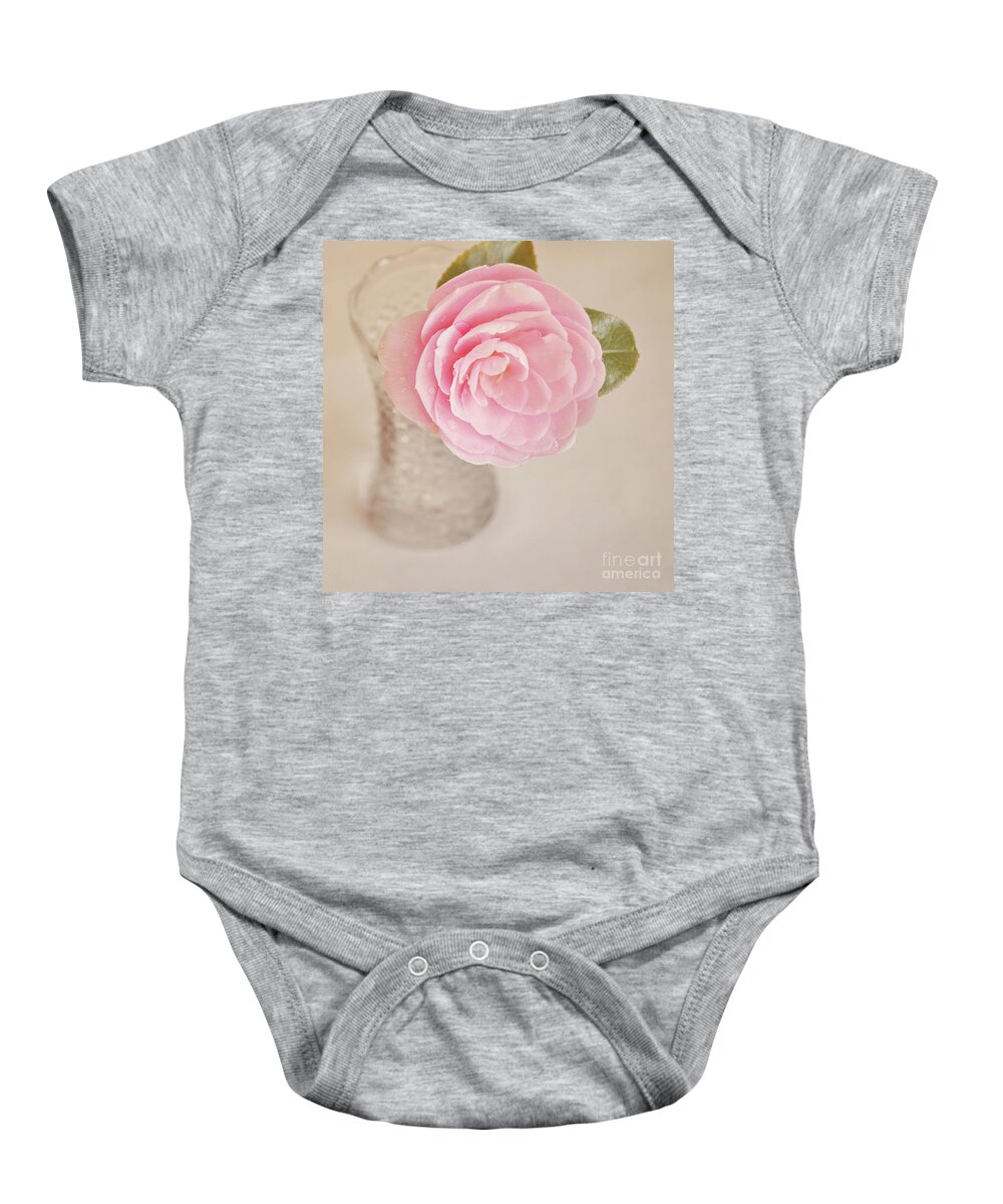 Camelia Baby Onesie featuring the photograph Single pink Camelia flower in clear vase by Lyn Randle