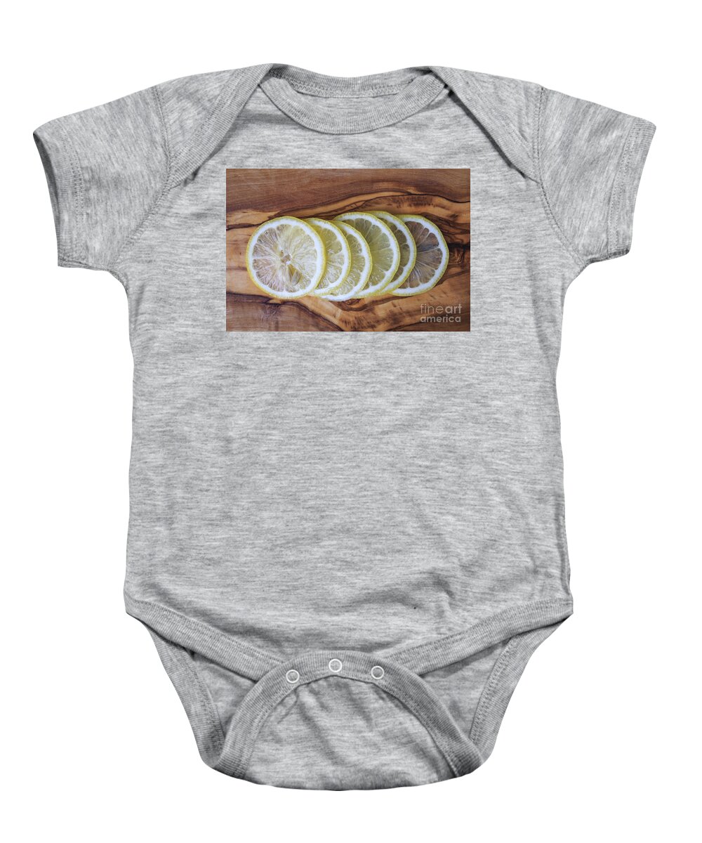 Lemons Baby Onesie featuring the photograph Slices of lemon by Edward Fielding
