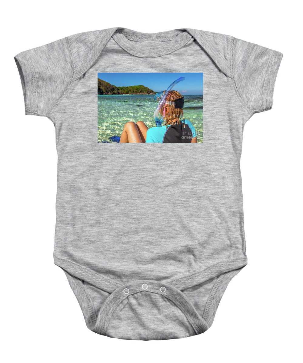 Snorkeler Baby Onesie featuring the photograph Snorkeler relaxing on tropical beach by Benny Marty