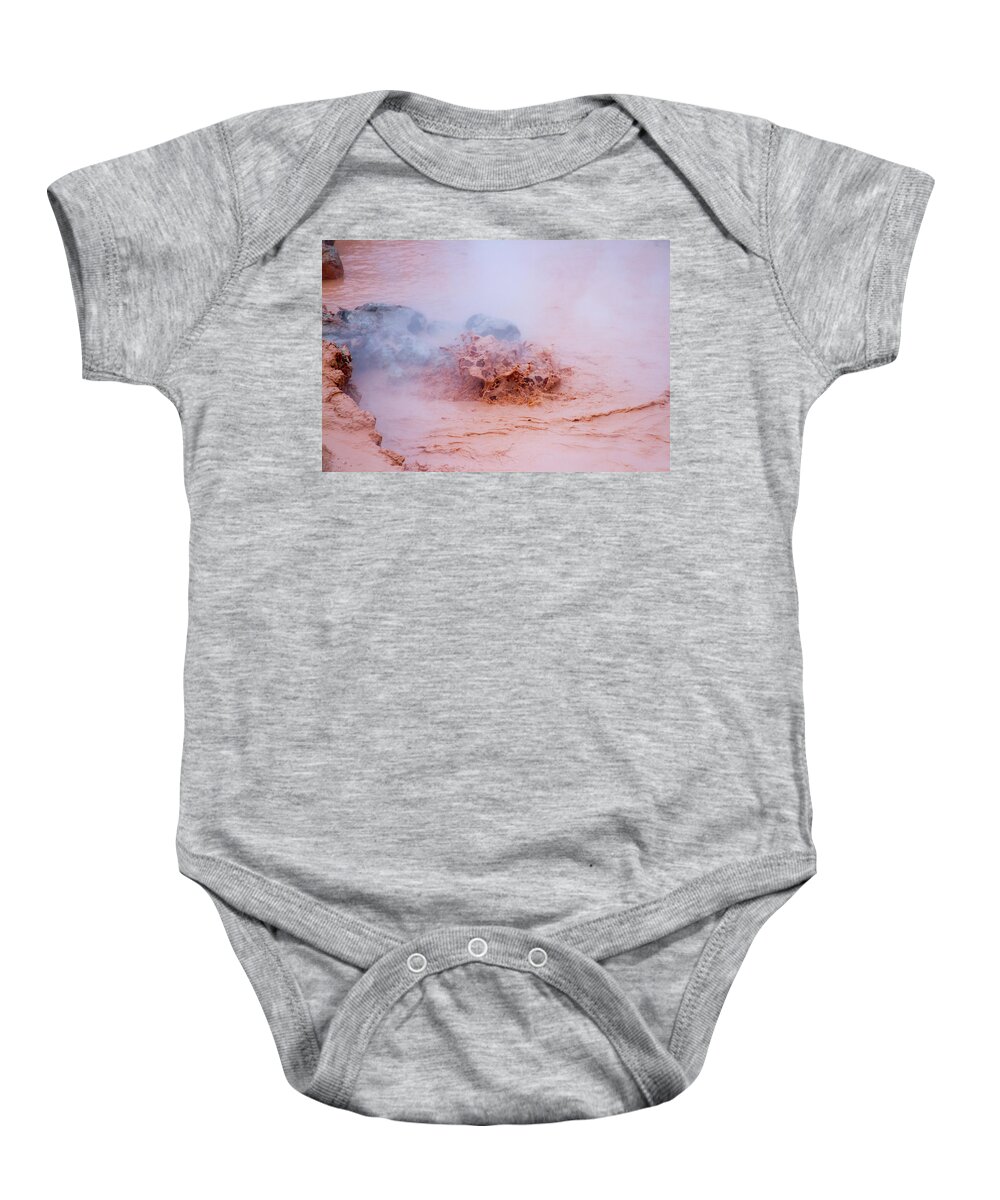 America Baby Onesie featuring the photograph Splashing mud in hot pots at Fountain Paint Pots in Yellowstone by Karen Foley