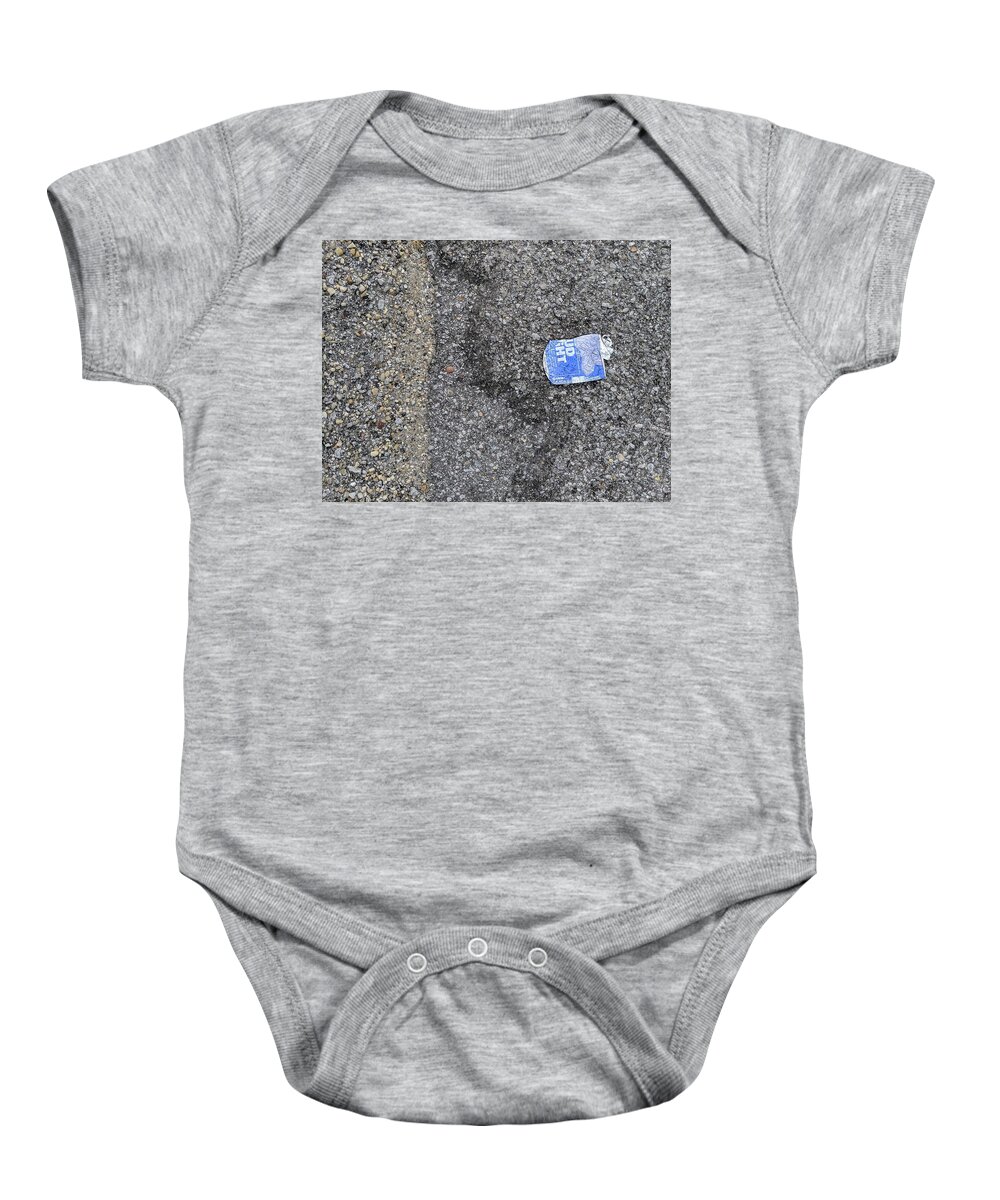 Budlitter Baby Onesie featuring the photograph #BudLitter and Two Types of Asphalt Aggregate by Jeremy Butler
