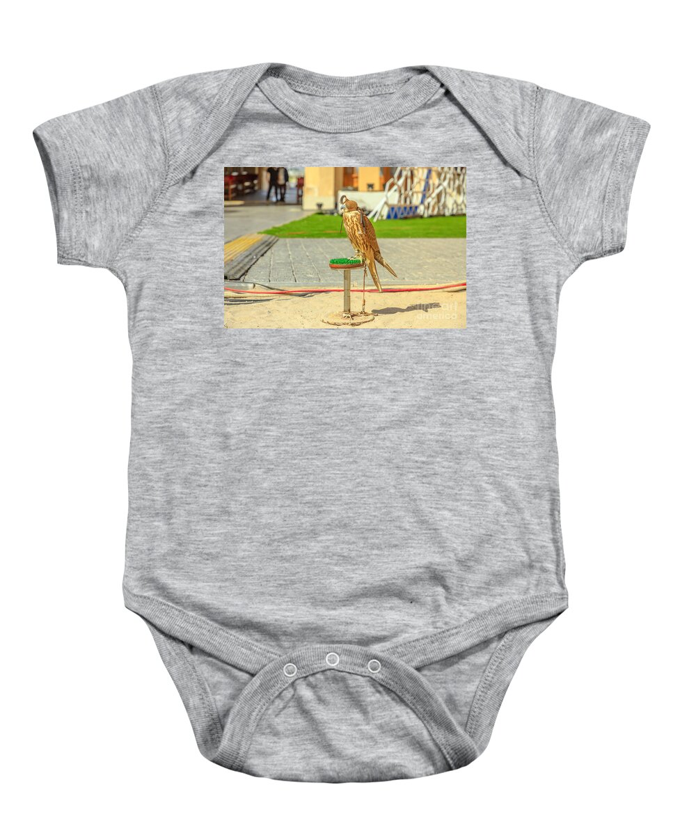 Falcon Baby Onesie featuring the photograph Falcon at Falcon Souk by Benny Marty
