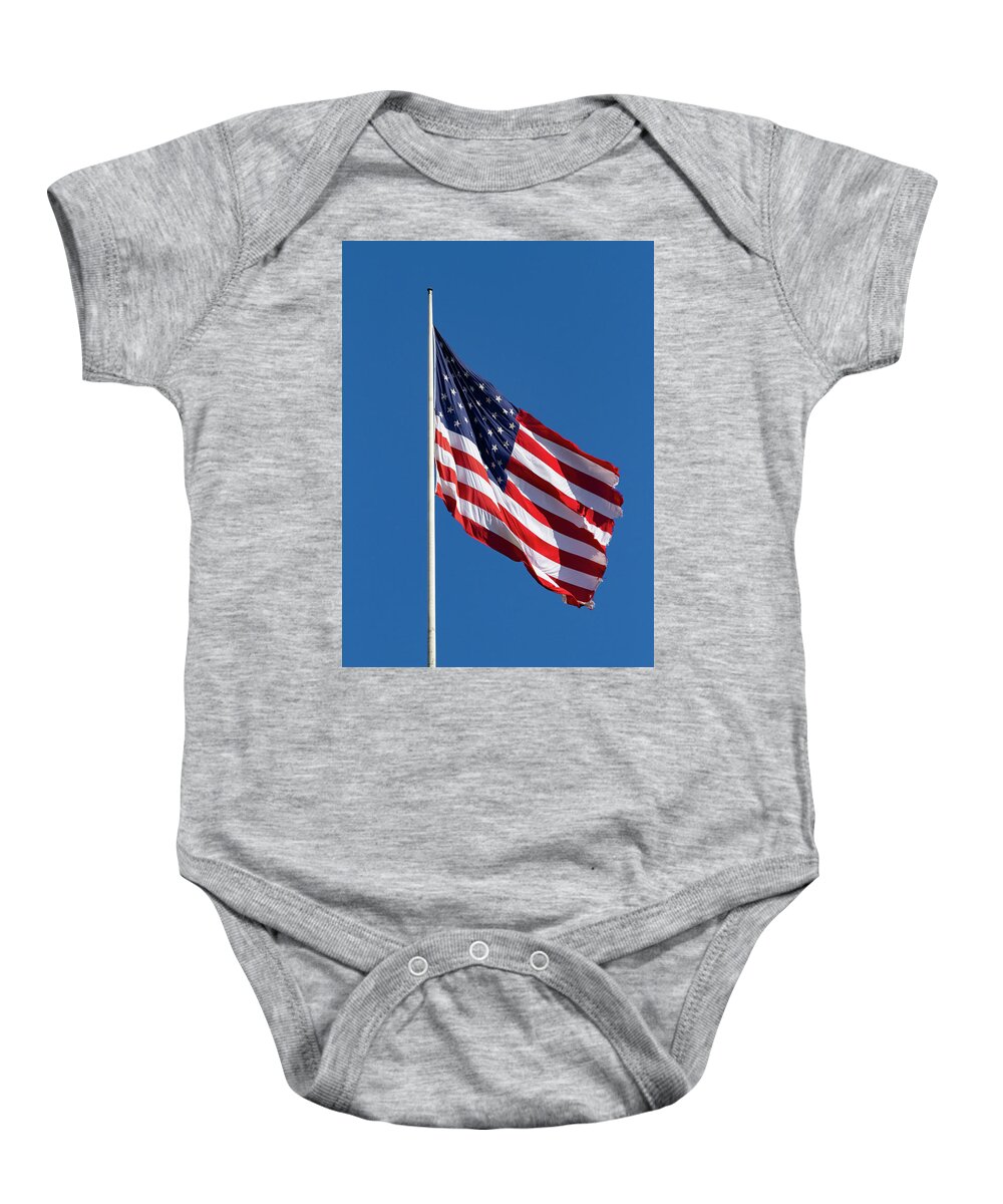 Long May She Wave Baby Onesie featuring the photograph Long May She Wave by Bonnie Follett