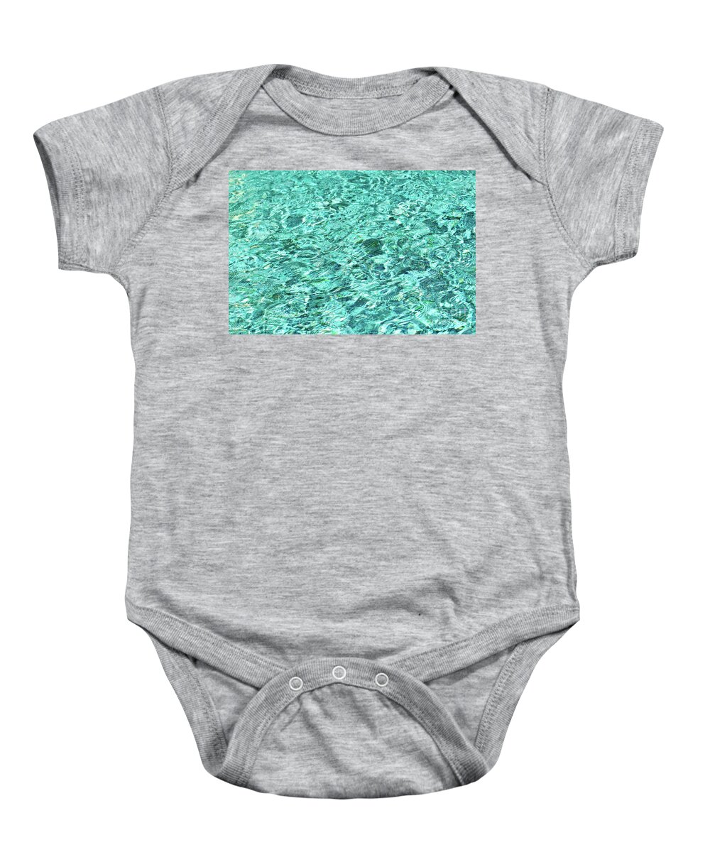 Water Surface Baby Onesie featuring the photograph Moving turquoise wavy water creates an abstract textured surface. by Ulrich Wende