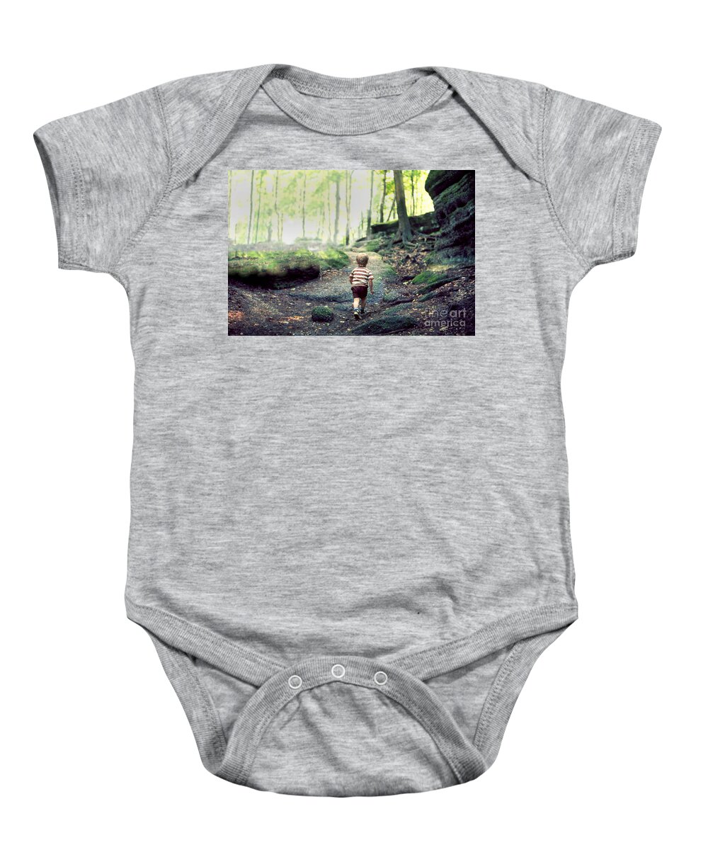 Hiking Baby Onesie featuring the photograph Three year old small boy child hiking alone on an uphill trail in a boulder strewn deciduous forest by Robert C Paulson Jr