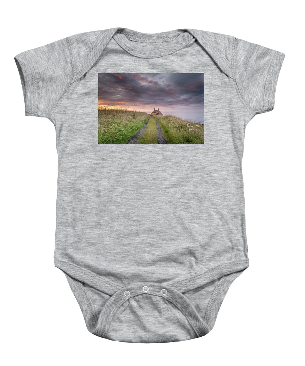 Northumberland Baby Onesie featuring the photograph A cottage by the sea by Anita Nicholson