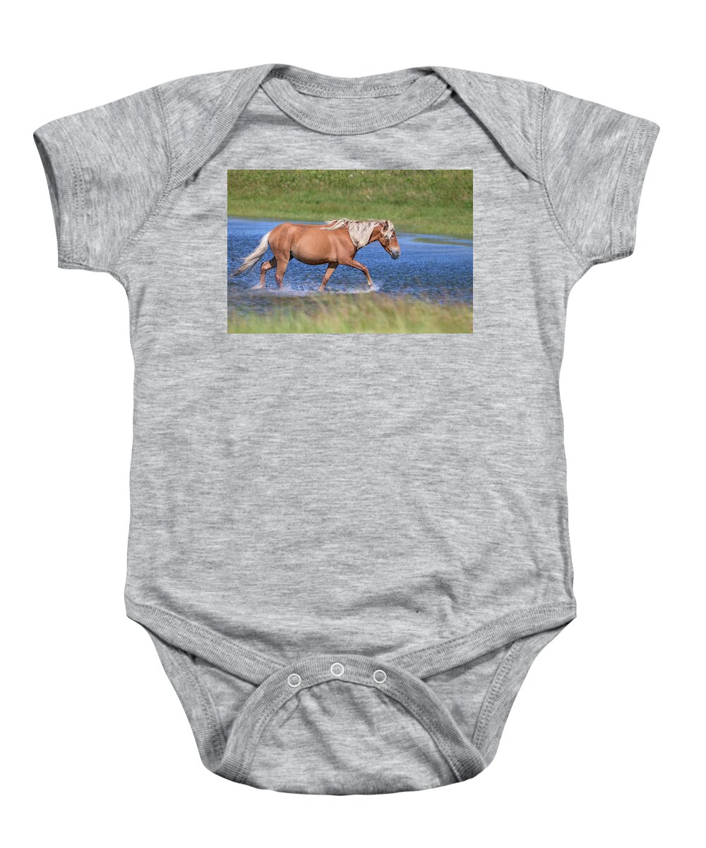  Baby Onesie featuring the photograph A Sable Island palomino bachelor stallion in the pond by Jen Britton