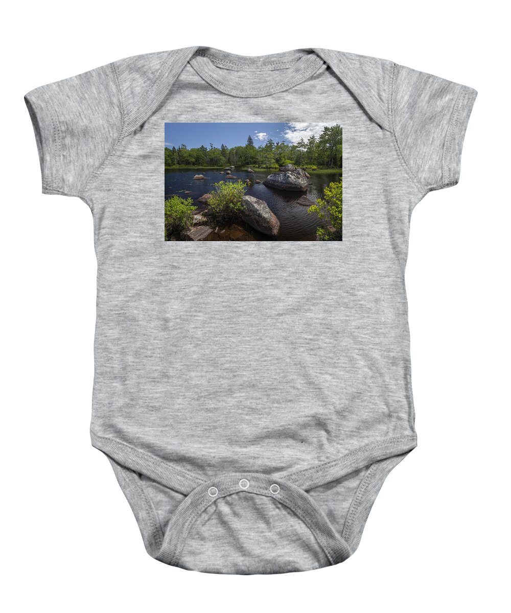 Late Spring Baby Onesie featuring the photograph A small rocky lake near Maple Lake by Irwin Barrett