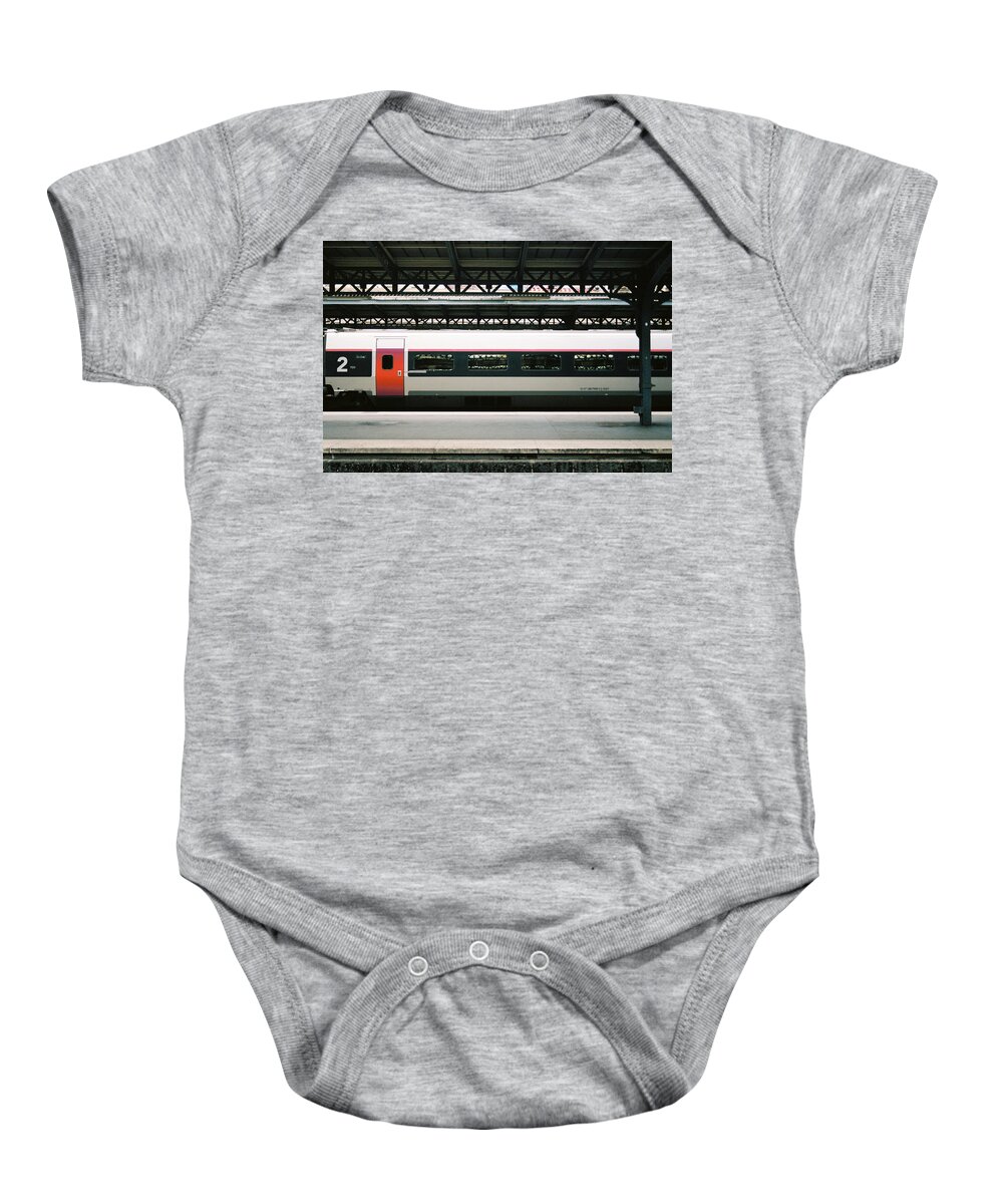 Train Baby Onesie featuring the photograph A train waiting on deck the next passengers by Barthelemy De Mazenod