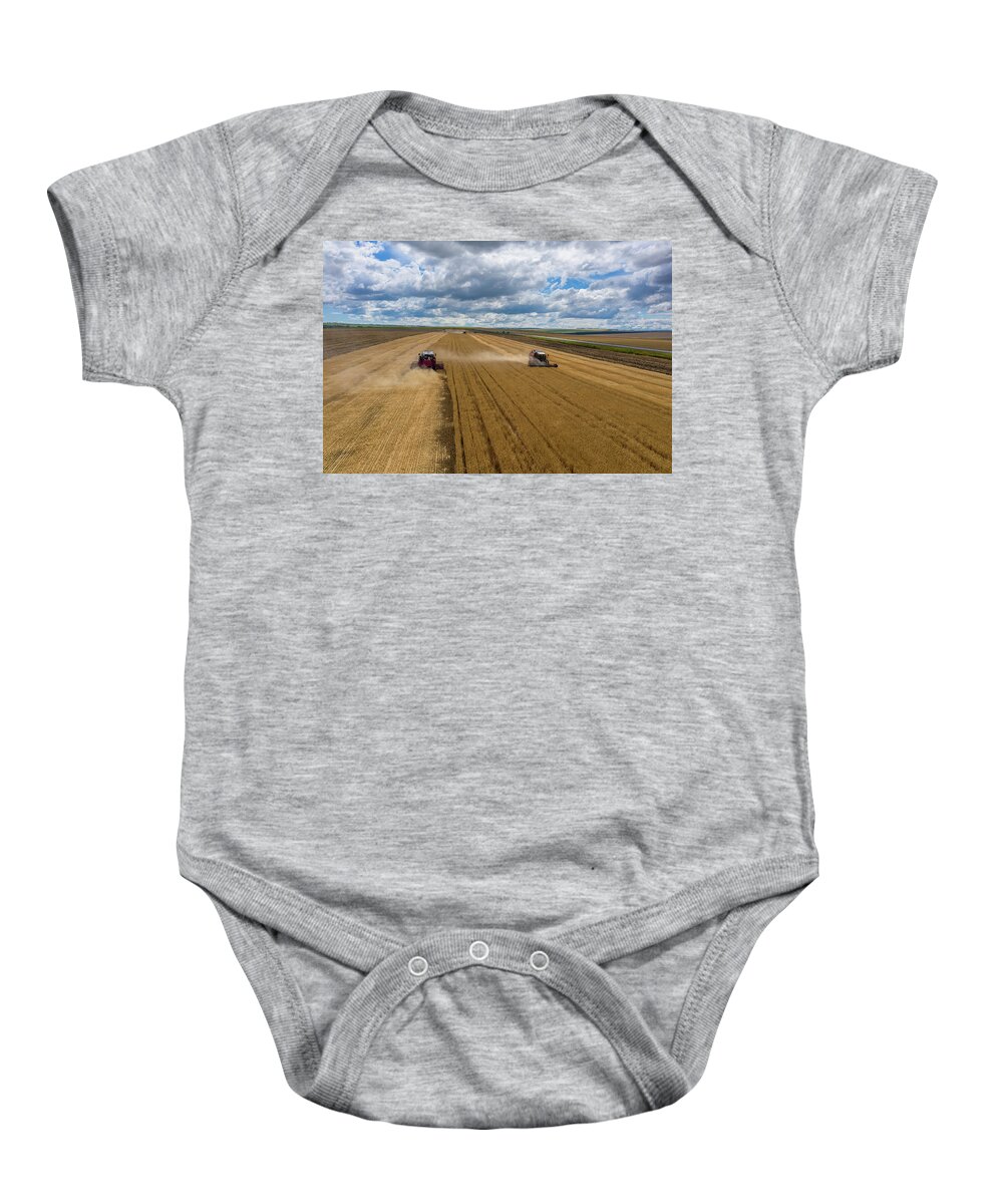 Agriculture Baby Onesie featuring the photograph Aerial view of combine on harvest field by Mikhail Kokhanchikov