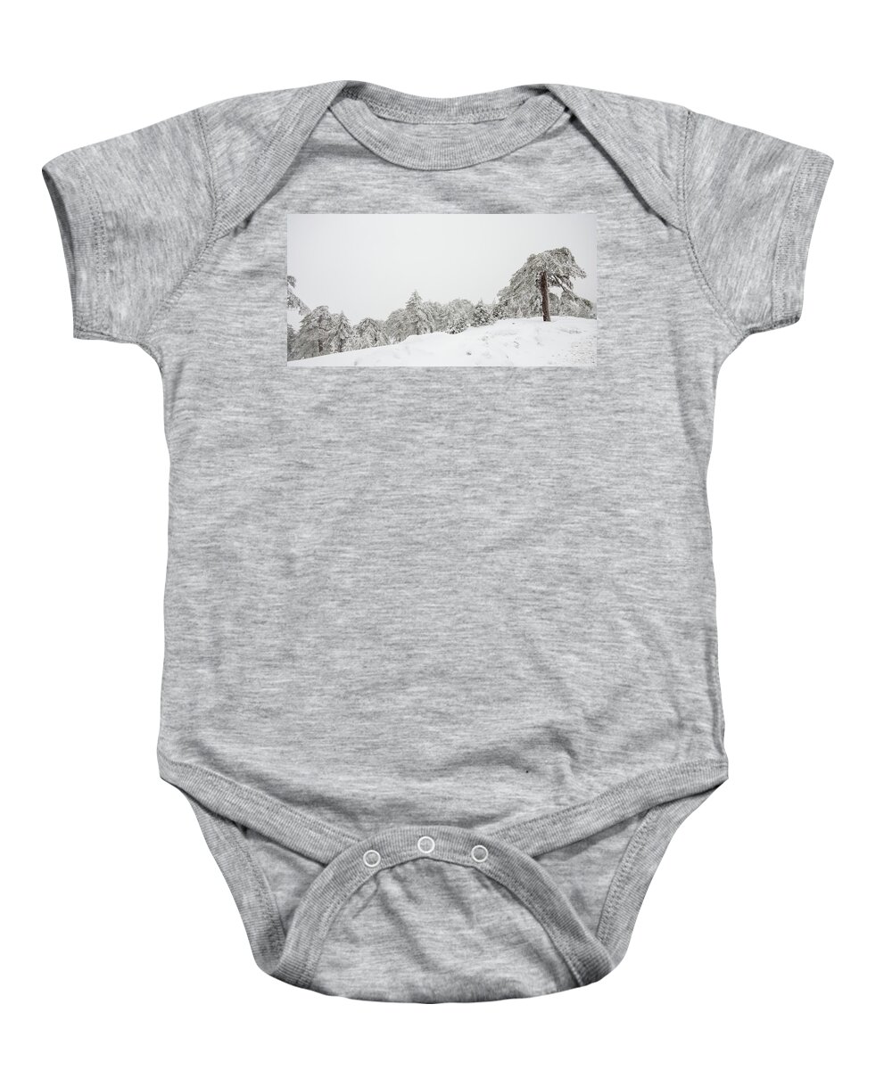 Snowstorm Baby Onesie featuring the photograph Forest landscape in snowy mountains. Snowstorm and frozen snow covered fir trees in winter season. by Michalakis Ppalis