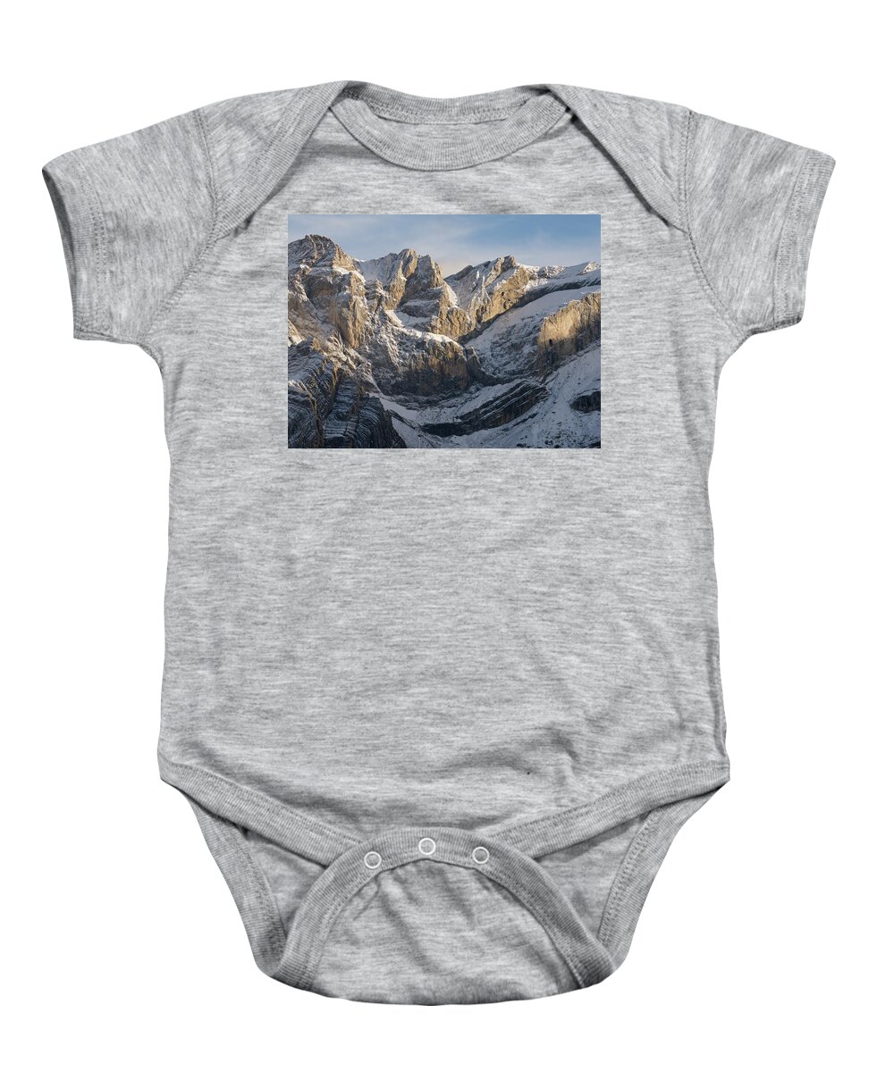 Gavarnie Baby Onesie featuring the photograph Golden Lights hits the snow capped peak of Pic de Marbore by Stephen Taylor