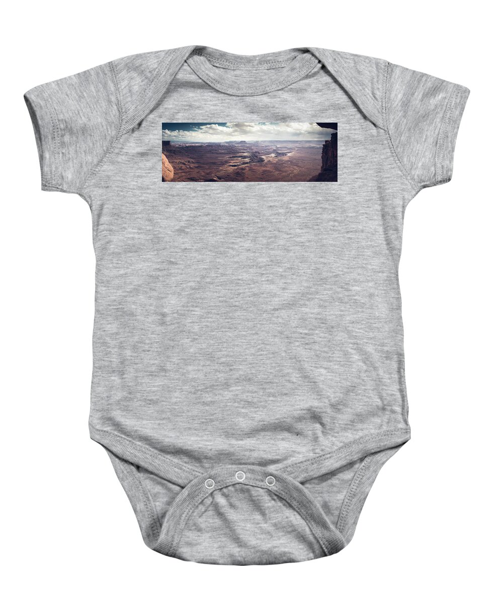 America Baby Onesie featuring the photograph Scenic view in canyonland with storm in the distance by Jean-Luc Farges